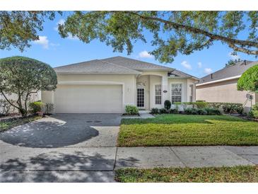 Charming single-story home with a well-manicured lawn and a two-car garage at 212 Stonington Way, Deland, FL 32724