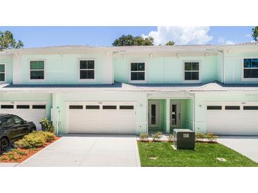 Inviting two-story townhome with attached garage and manicured landscaping at 559 Coronado Cove Rd, New Smyrna Beach, FL 32168