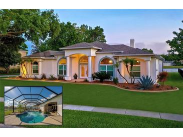 Beautiful single-story home with manicured lawn, mature trees, and a screened-in pool, offering an inviting outdoor oasis at 6071 Sabal Hammock Cir, Port Orange, FL 32128