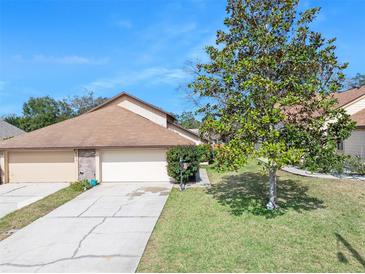 Charming home featuring a two-car garage, well-maintained lawn, and lovely curb appeal at 6157 Sequoia Dr, Port Orange, FL 32127