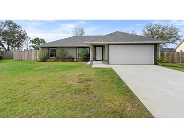 Charming home featuring a well-manicured lawn, inviting entrance and a two car garage at 1763 Efland Ter, Deltona, FL 32738