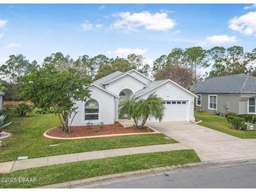 Charming single-story home with well-manicured lawn and mature landscaping at 232 Gala Cir, Daytona Beach, FL 32124