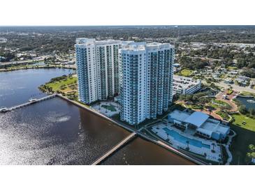 Aerial view of two modern high-rise condo towers on the water with lush landscaping and community pool at 241 Riverside Dr # 1502, Daytona Beach, FL 32117