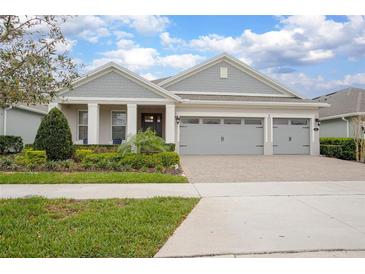Charming single-story home featuring a three-car garage, manicured landscaping, and a welcoming front porch at 291 Northcote Ct, Deland, FL 32724