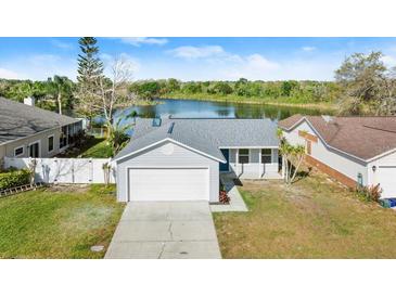 Aerial view of a home near a lake, showcasing the property and surrounding landscape at 3813 Long Grove Ln, Port Orange, FL 32129