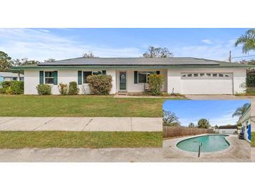 Well-maintained single-story home with solar panels and a nicely landscaped front yard and a pool at 445 Virginia Ave, St Cloud, FL 34769