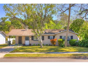 Charming single-story home featuring a well-manicured lawn, mature trees, and cozy curb appeal at 741 Greenway Pl, Daytona Beach, FL 32114