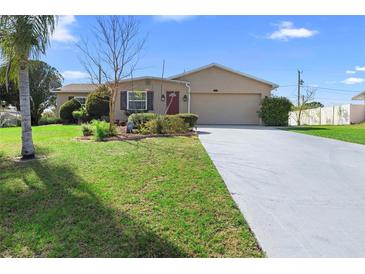 Charming single-story home featuring a well-manicured lawn and a spacious two-car garage at 826 W Gaucho Cir, Deltona, FL 32725