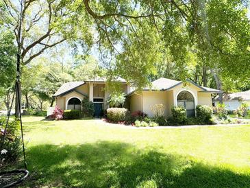 Charming home featuring lush landscaping and a well-manicured lawn, creating inviting curb appeal at 1226 Deer Lake Cir, Apopka, FL 32712