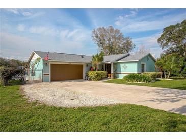 Charming single-story home featuring a two-car garage, and well-maintained landscaping, showcasing curb appeal at 1258 Russell Dr, Ocoee, FL 34761