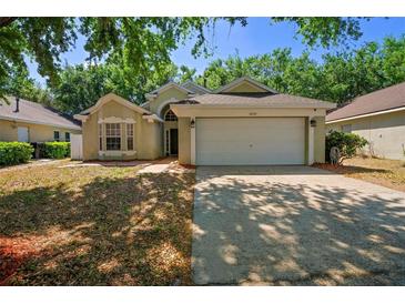 Charming single-story home with a spacious two-car garage and mature landscaping at 2859 Doe Run Trl, Orange City, FL 32763