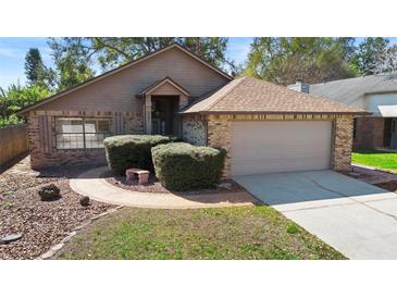 Charming single-story home with brick accents, neat landscaping, and a two-car garage at 3021 Little Cypress Cv, Winter Park, FL 32792