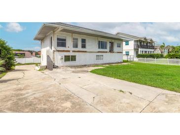 Two-story home featuring a spacious driveway and a lush green yard at 4734 S Atlantic Ave, Ponce Inlet, FL 32127