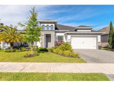 Beautiful single Gathering home with manicured lawn and a two car garage at 6271 W Fallsgrove Ln, Port Orange, FL 32128