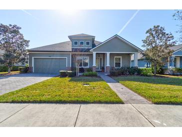 Charming one-story home featuring a well-manicured lawn, covered porch, and neutral paint scheme at 1204 Draycott St, Ormond Beach, FL 32174
