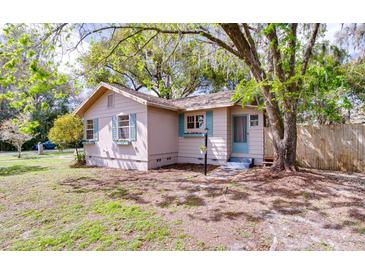 Charming home featuring light-colored siding, blue shutters, and flower boxes under the windows at 201 W Central Ave, Orange City, FL 32763