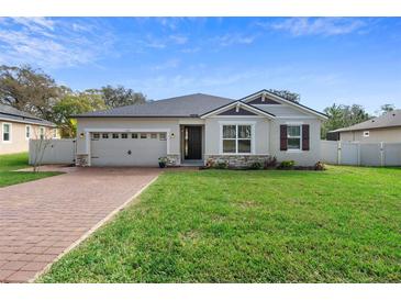 Charming single-story home with brick driveway and well-manicured lawn at 2393 Oxmoor Dr, Deland, FL 32724