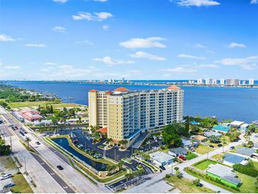 Stunning aerial view of a waterfront condo building offering beautiful views of the water and city skyline at 2801 S Ridgewood Ave # 1214, South Daytona, FL 32119