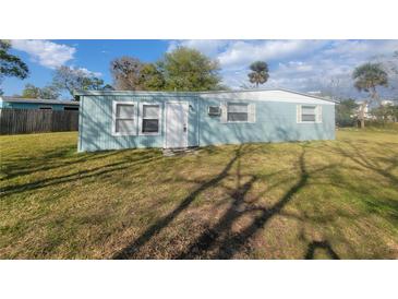 Charming single-story home with light blue exterior, white trim, and well-maintained lawn at 305 Elsie Ave, Daytona Beach, FL 32117