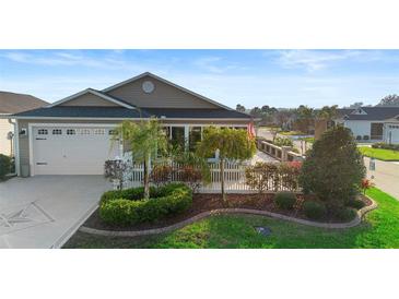 Charming home with a well-manicured front yard, beautiful landscaping, and an inviting entrance at 3102 Cordgrass Ct, The Villages, FL 32163