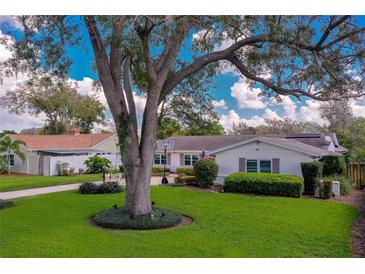Charming single Gathering home with a beautiful landscaped yard with mature trees in a sunny neighborhood at 901 Ponca Trl, Maitland, FL 32751