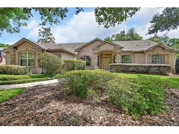 Beautiful home with a meticulously landscaped front yard and a stone-accented facade at 1491 W Silver Hammock, Deland, FL 32720