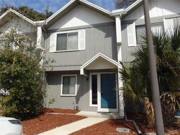 Charming townhome featuring a blue front door, gray siding and white trim at 3960 Willow Trail Run # 45, Port Orange, FL 32127