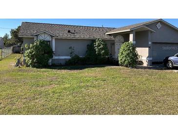 Charming single-story home with lush front lawn and mature landscaping at 662 Comstock Dr, Deltona, FL 32738