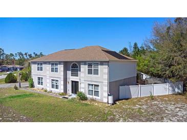 Two-story home with a large front lawn and a combination of stucco and horizontal siding at 707 Leeward Dr, Deltona, FL 32738