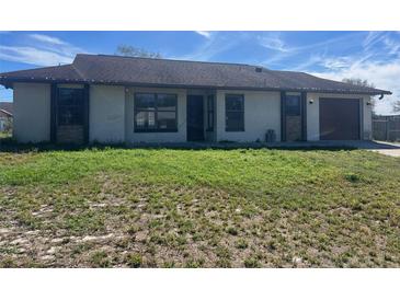 Charming single-story home featuring a front yard and attached garage at 925 Roswell Ter, Deltona, FL 32738