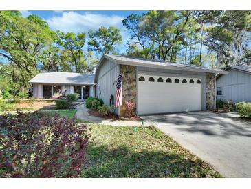 Charming single-story home with stone accents, a two-car garage, and mature landscaping in a quiet neighborhood at 29 Ramblewood Trl, Deland, FL 32724