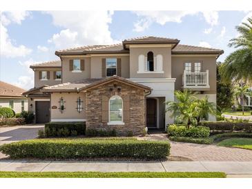 Beautiful two-story home featuring manicured landscaping, a tile roof, and a welcoming entrance at 3955 Equine Cv, Lake Mary, FL 32746