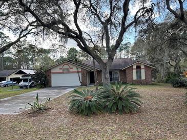 Charming single-story home with a two-car garage and mature landscaping in a quiet neighborhood at 4164 New Marsh Rd, Deland, FL 32724