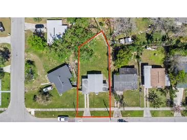 Aerial view of property showing the home, yard, and surrounding neighborhood with a boundary line in red at 4333 Arch St, Orlando, FL 32808
