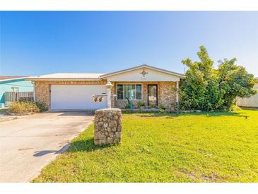 Charming home with stone accents, well-maintained lawn and a metal roof at 44 Sunset Blvd, Ormond Beach, FL 32176