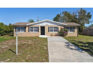 Charming single-story home featuring a well-manicured lawn, tidy landscaping, and a welcoming front entrance at 1020 Alladin Dr, Deltona, FL 32725