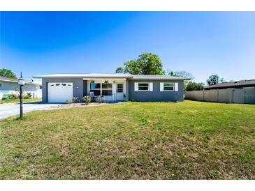 Charming single story home with a well-maintained front yard and a single car garage at 1199 Galgano Ave, Deltona, FL 32725