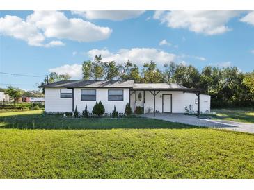 Charming single-story home with a well-maintained lawn and inviting front porch at 1265 Aquarius Ave, Deland, FL 32724