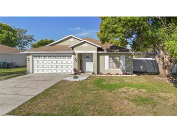 Charming single-story home featuring a well-maintained lawn and a two-car garage at 1340 Babcock Ave, Deltona, FL 32725