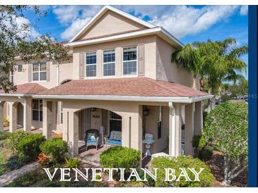 Charming two-story townhome features a covered front porch with seating and well-maintained landscaping at 3620 Tresto St, New Smyrna Beach, FL 32168