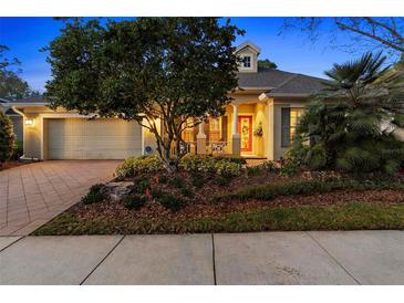 Charming home featuring a well-maintained front yard, manicured landscaping, and a welcoming red front door at 509 Victoria Hills Dr, Deland, FL 32724