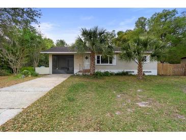 Charming single-story home with a well-maintained lawn and mature palm trees at 514 Land O Lakes Ct, Deland, FL 32724