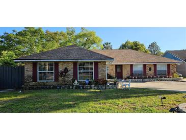 Charming single-story brick home with red shutters and well-manicured landscaping at 520 Dixson St, Orange City, FL 32763