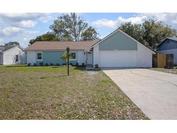 Charming single-story home featuring a well-manicured lawn and a two-car garage at 597 Gainsboro St, Deltona, FL 32725
