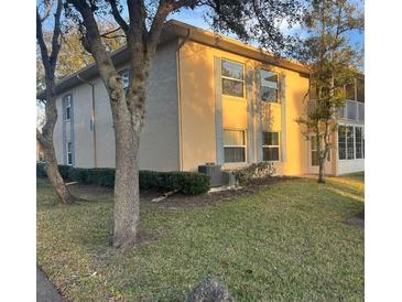 Inviting multi-Gathering unit featuring well-maintained landscaping and a serene, tree-lined view at 678 Wellington Station Blvd # 54, Ormond Beach, FL 32174