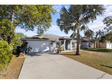 Charming single-story home featuring a well-manicured lawn, and a spacious two-car garage at 723 Pelican Ct, Kissimmee, FL 34759