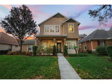 Charming two-story home features a welcoming front porch and beautifully landscaped lawn at 104 W Lake Victoria Cir, Deland, FL 32724