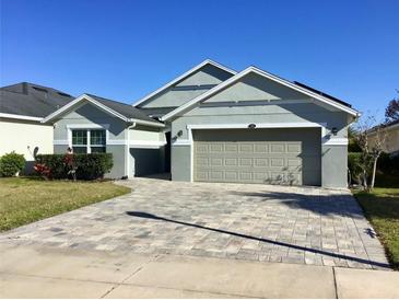Charming single-story home featuring a well-manicured lawn and a two car garage at 112 Grande Lake Dr, Daytona Beach, FL 32124