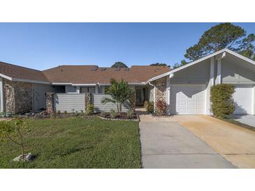 Charming home with a well-maintained lawn, stone accents, and an attached one-car garage at 120 Black Duck Cir, Daytona Beach, FL 32119