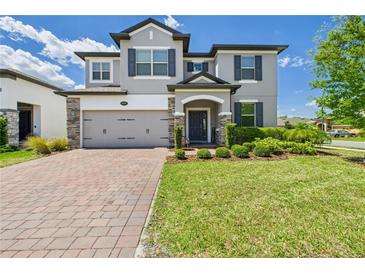 Charming two-story home with a well-manicured lawn and brick-paved driveway, blending elegance and curb appeal at 2090 Prairie Sage Ln, Longwood, FL 32750